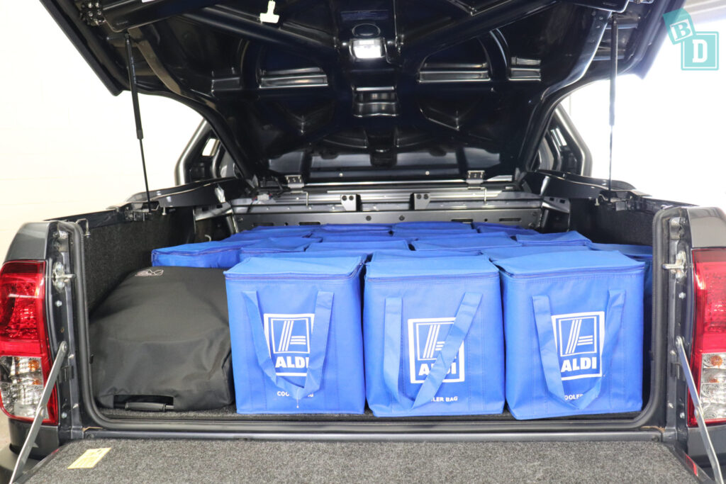 The 2023 Toyota HiLux Rogue truck is filled with blue bags and a compact stroller