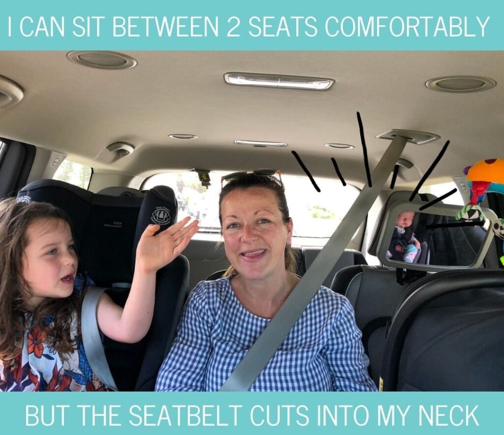 Sitting between two child seats in the Kia Carnival