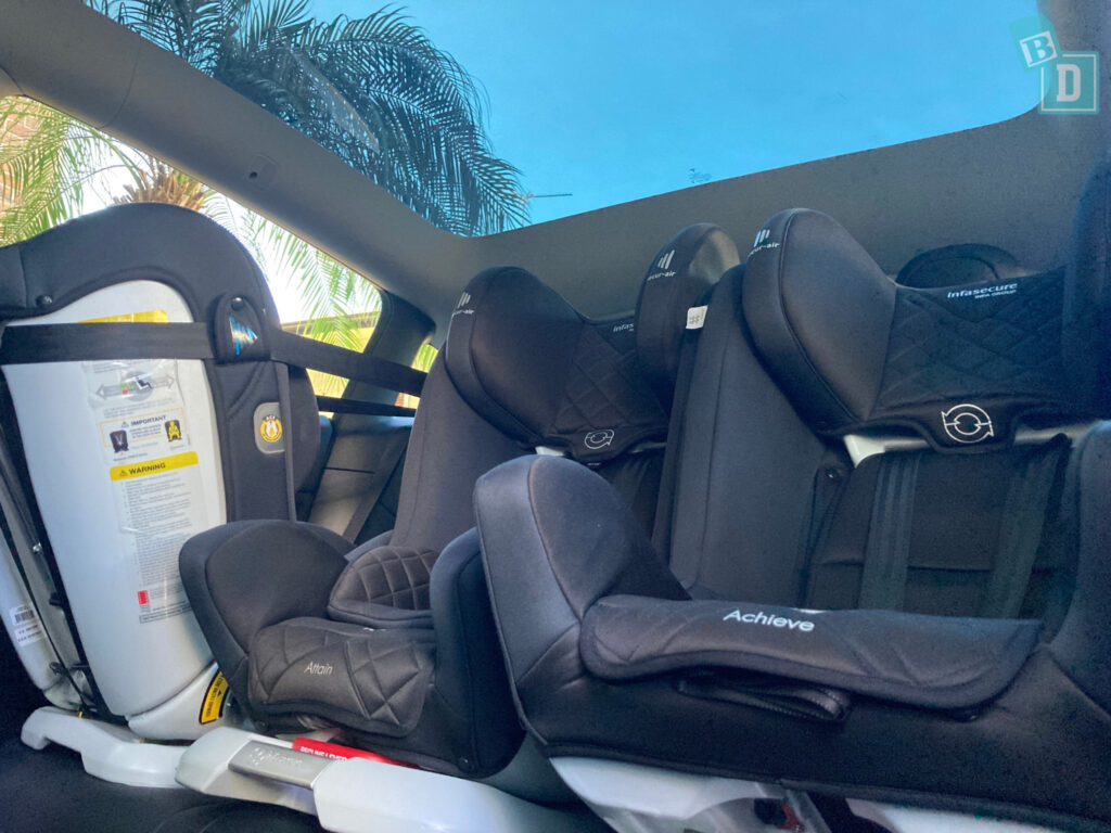 2023 Tesla Model Y with 3 child seats in the back seat.