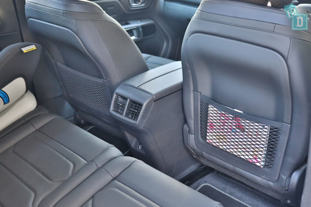 the back seats of a car with a seat cover.