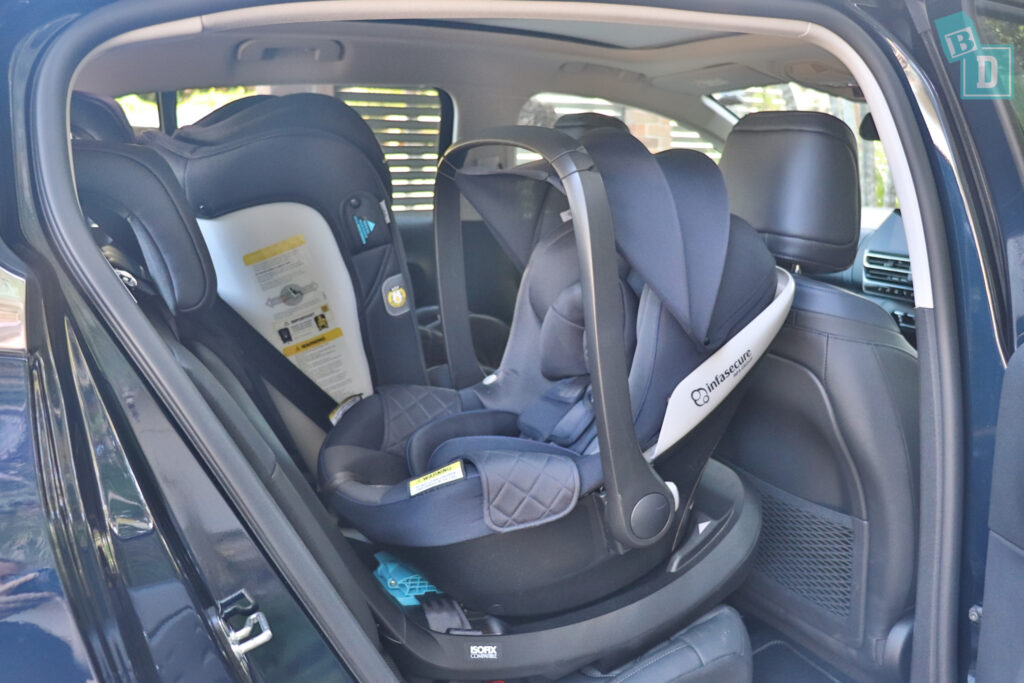 a car seat in the back seat of a car.