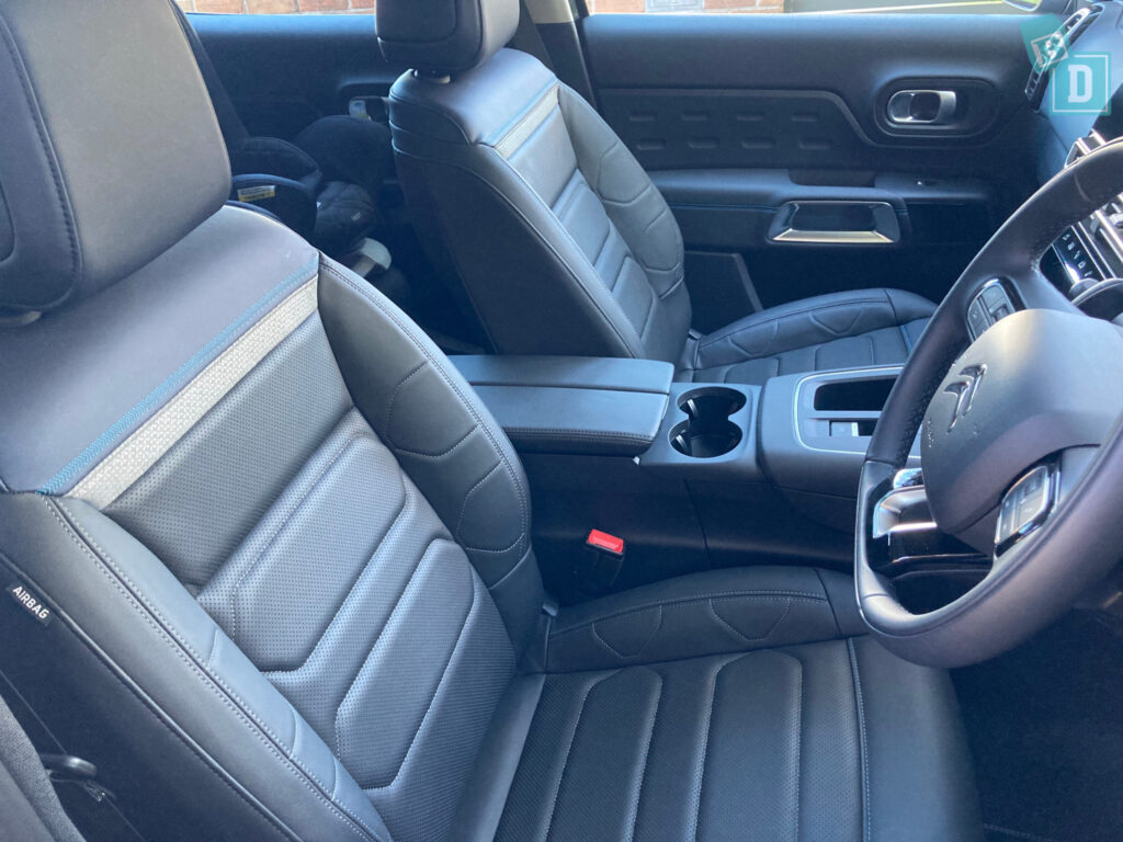 the interior of a car with black leather seats and steering wheel.