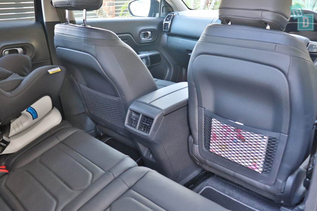 the back seats of a suv with a baby in the back seat.