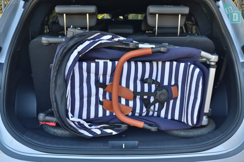 a baby stroller in the trunk of a 2023 Hyundai Santa Fe Hybrid when three rows of seats in use