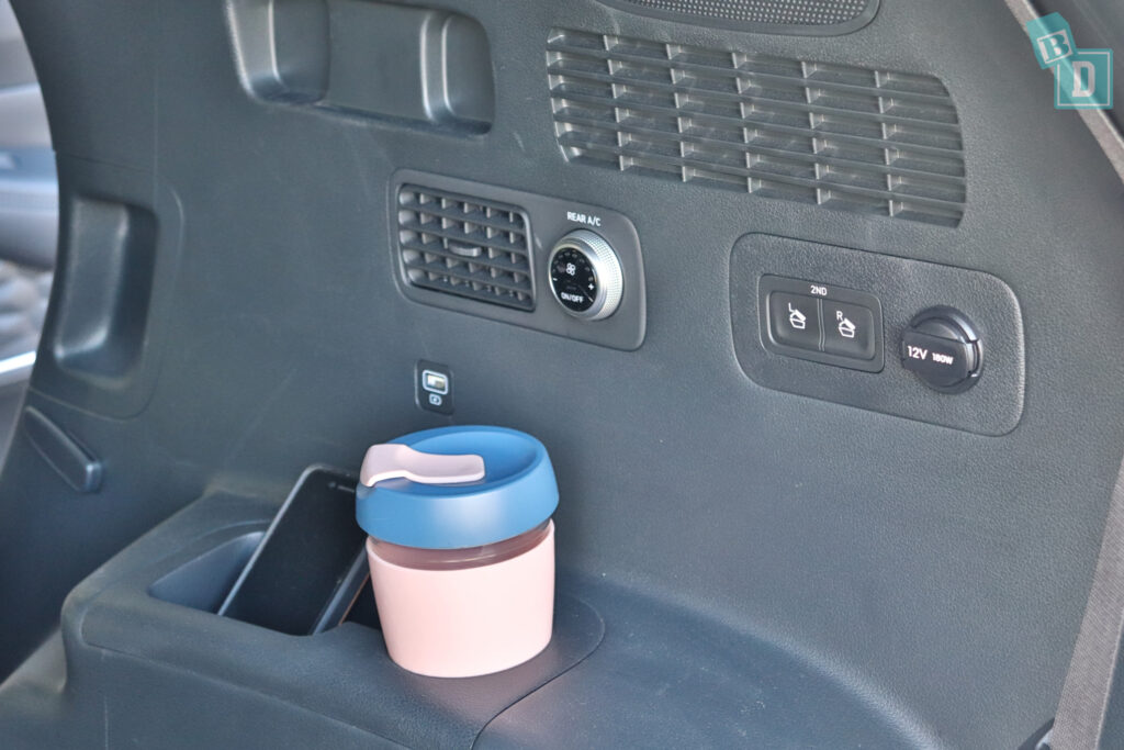 a cup of coffee is sitting in a cup holder in a car.