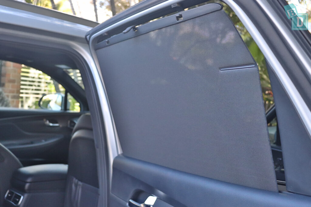 a car with a sunroof open and a door open.