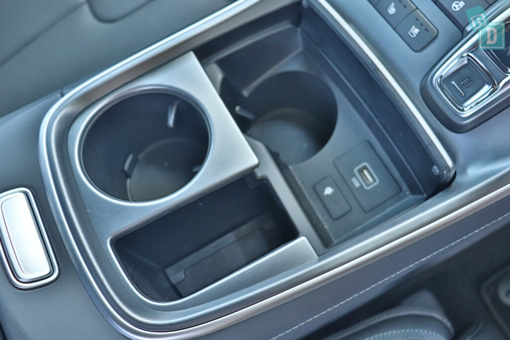 the interior of a car with a cup holder and cup holders.