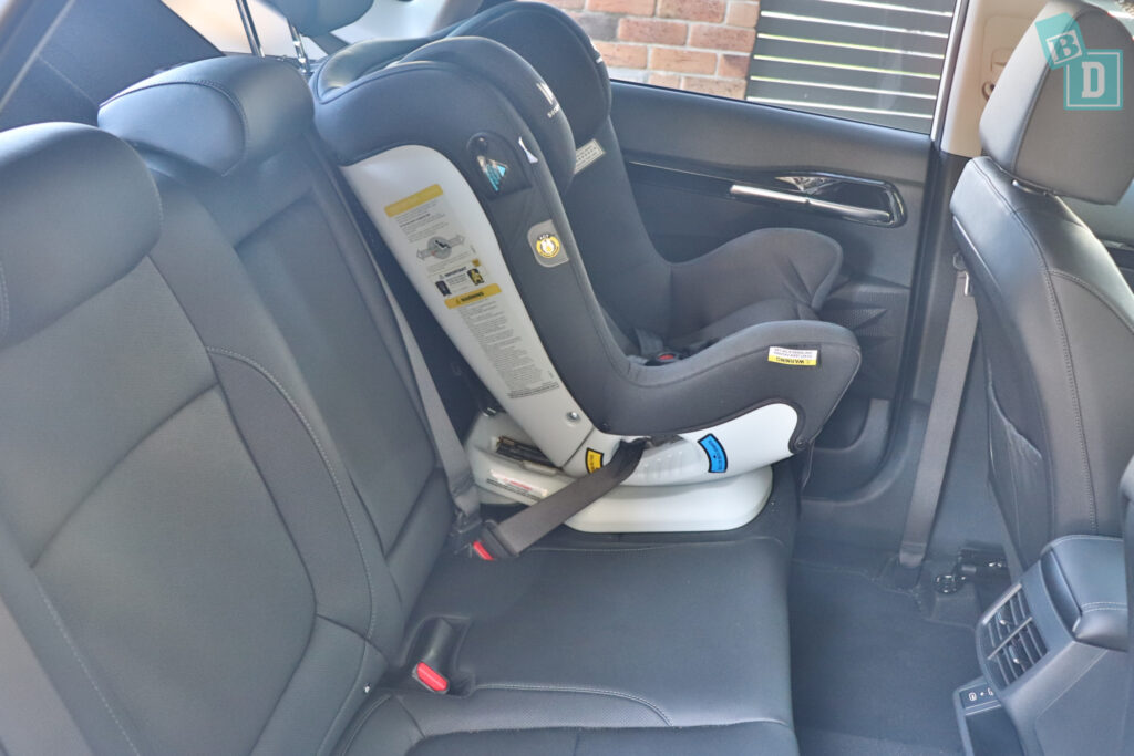 a car seat in the back seat of a 2023 Kia Seltos