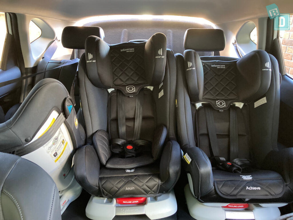 the back seat of a 2023 Kia Seltos with three child seats installed