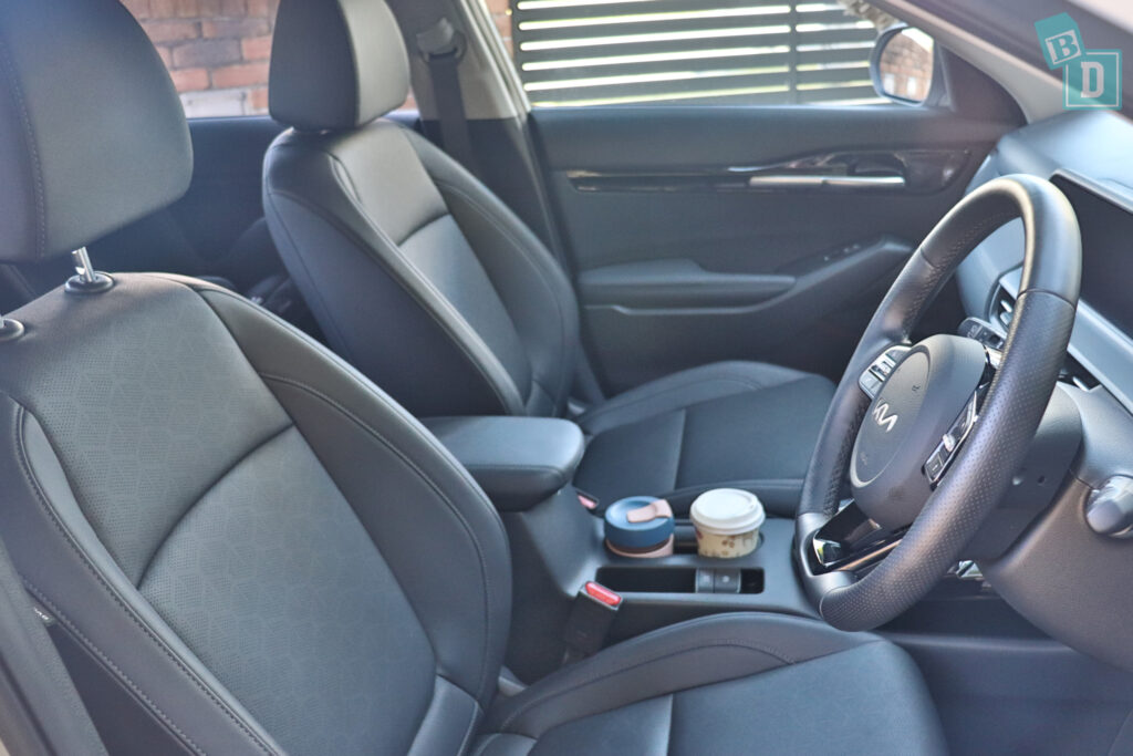 the interior of a car with black leather seats and steering wheel.