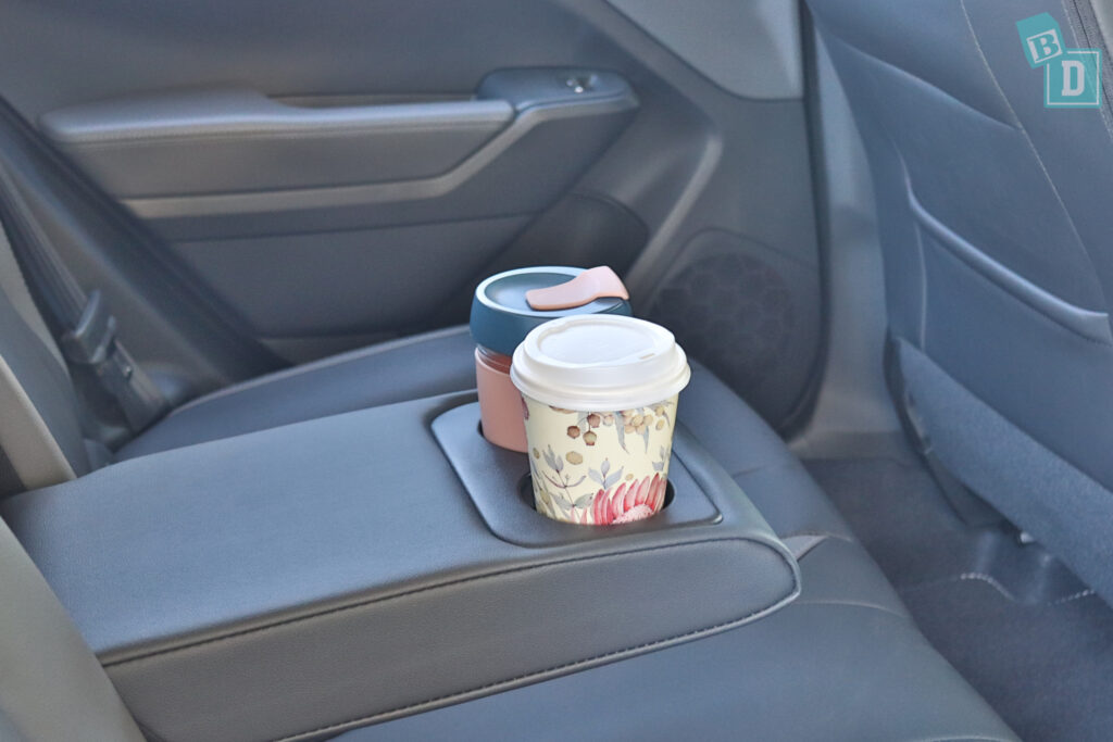 a cup holder in the back seat of a car.