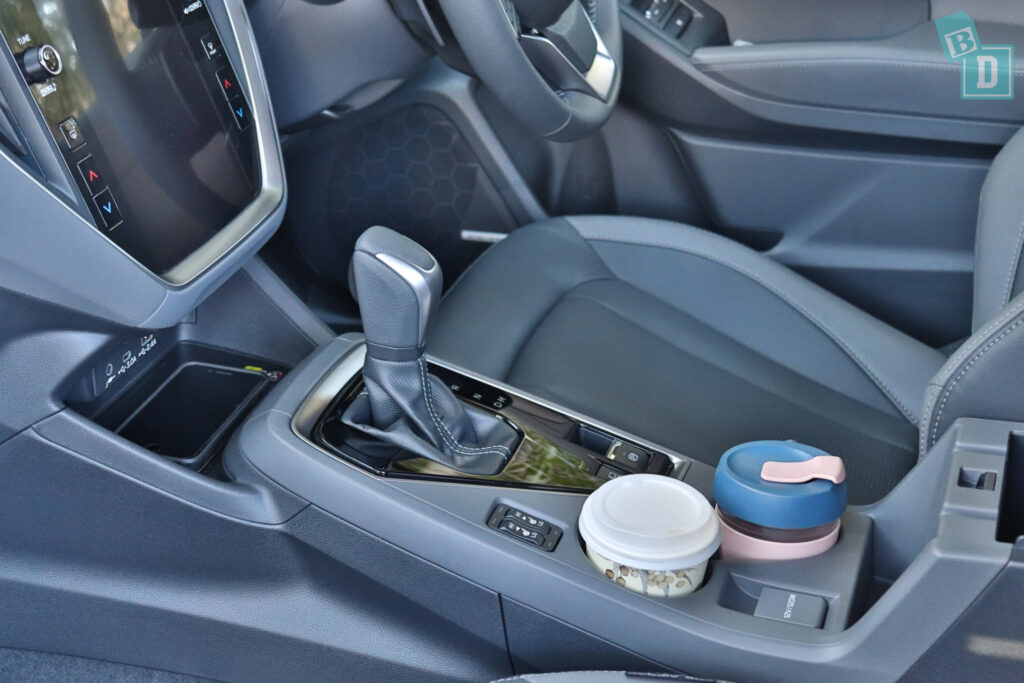 the dashboard of a car with a cup holder.