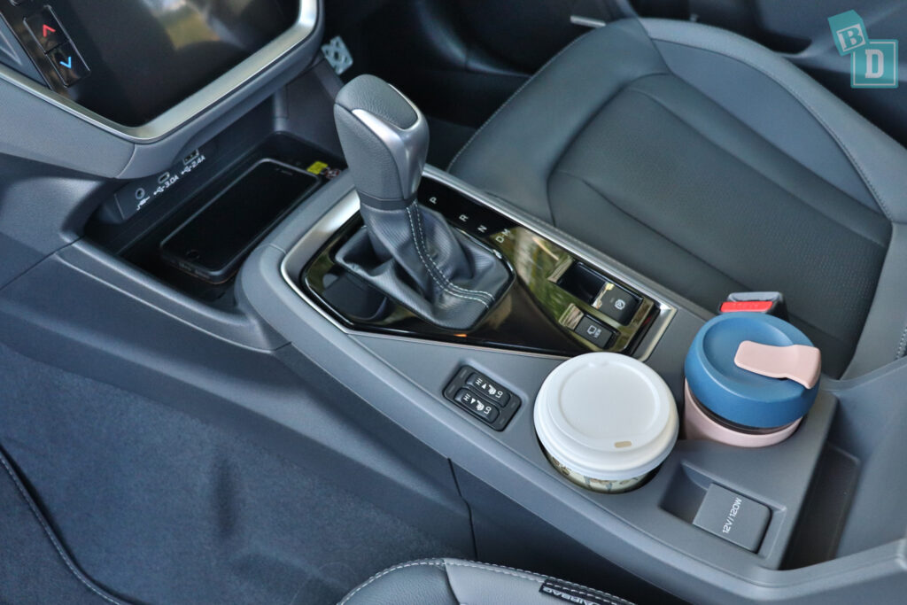 the interior of a car with a cup holder and cup holders.