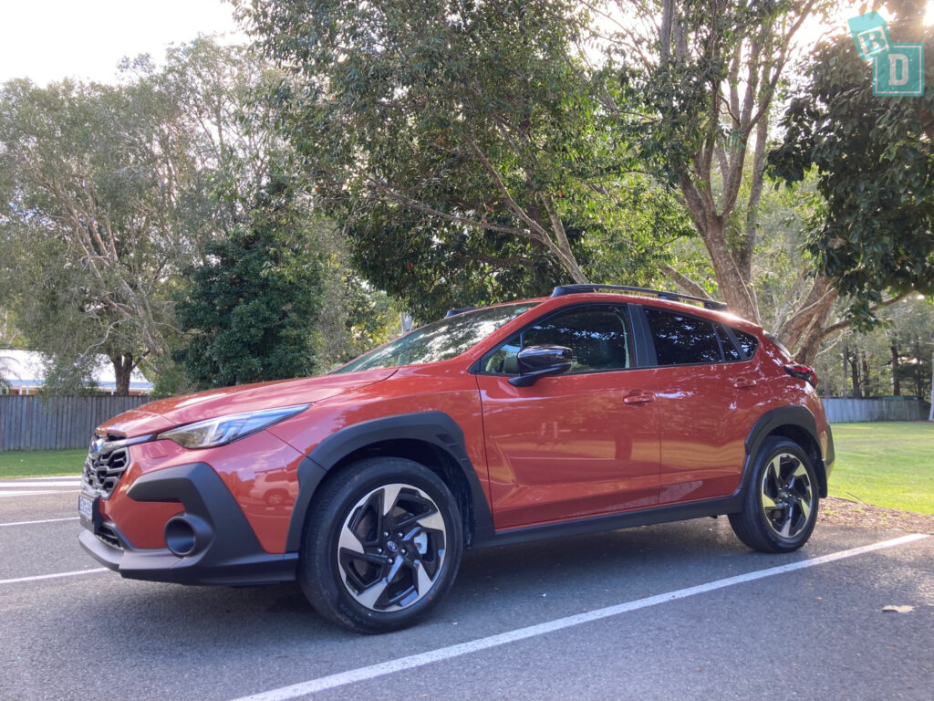 a red toyota rav4 parked in a parking lot.