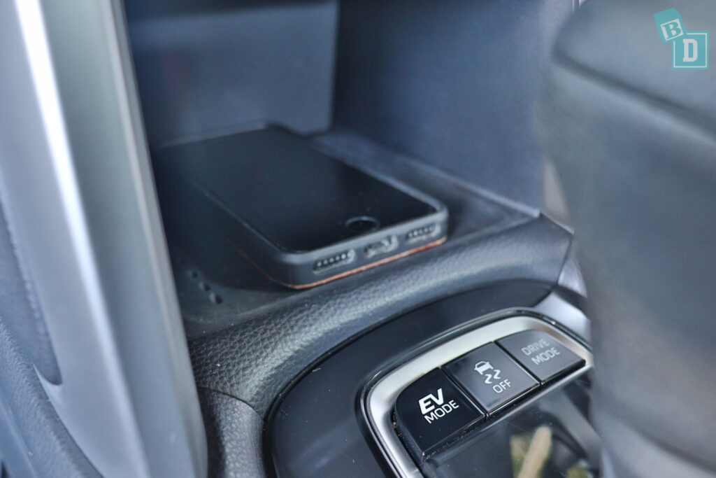 a car with a phone charger in the center console.