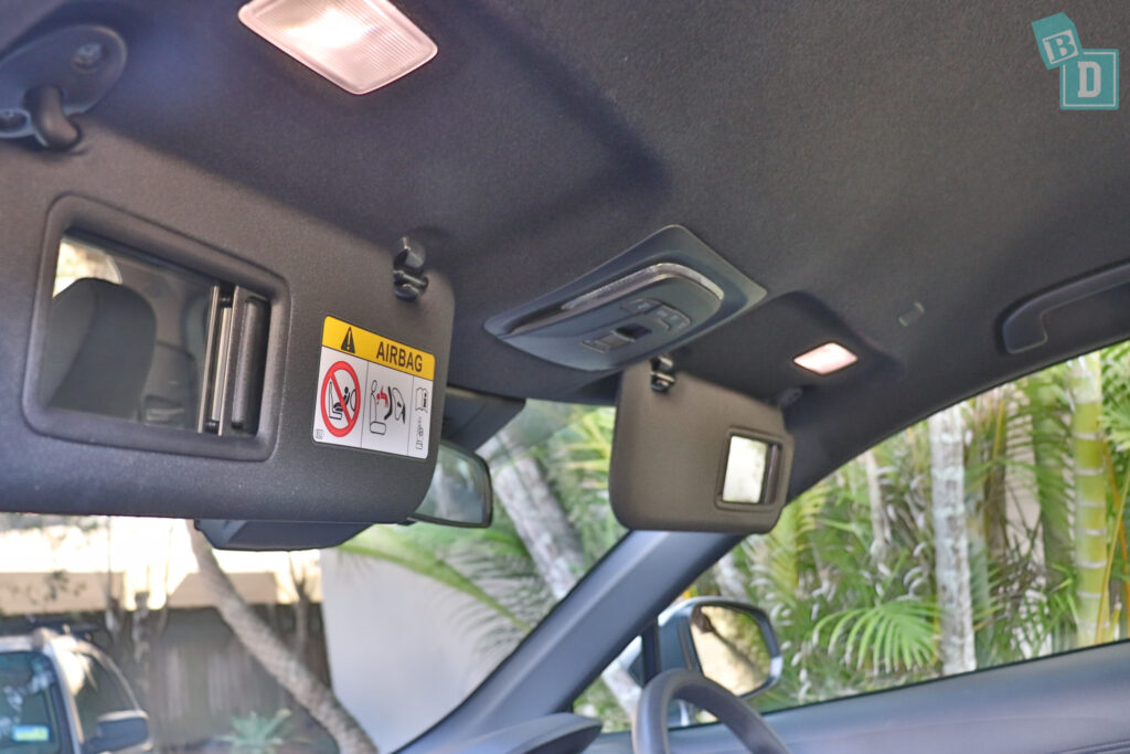 the interior of a car with a rear view mirror.