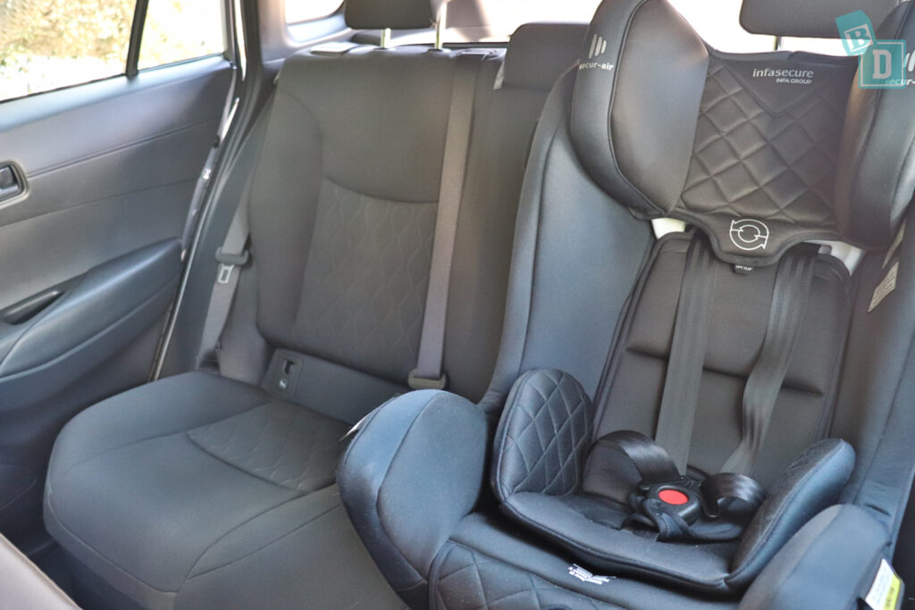 the back seat of a 2023 Toyota Corolla Cross hybrid with a child seat.