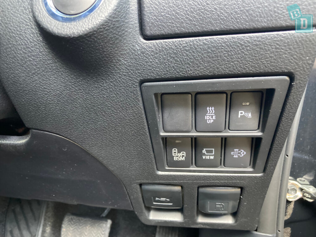 the control panel of a car with buttons on it.