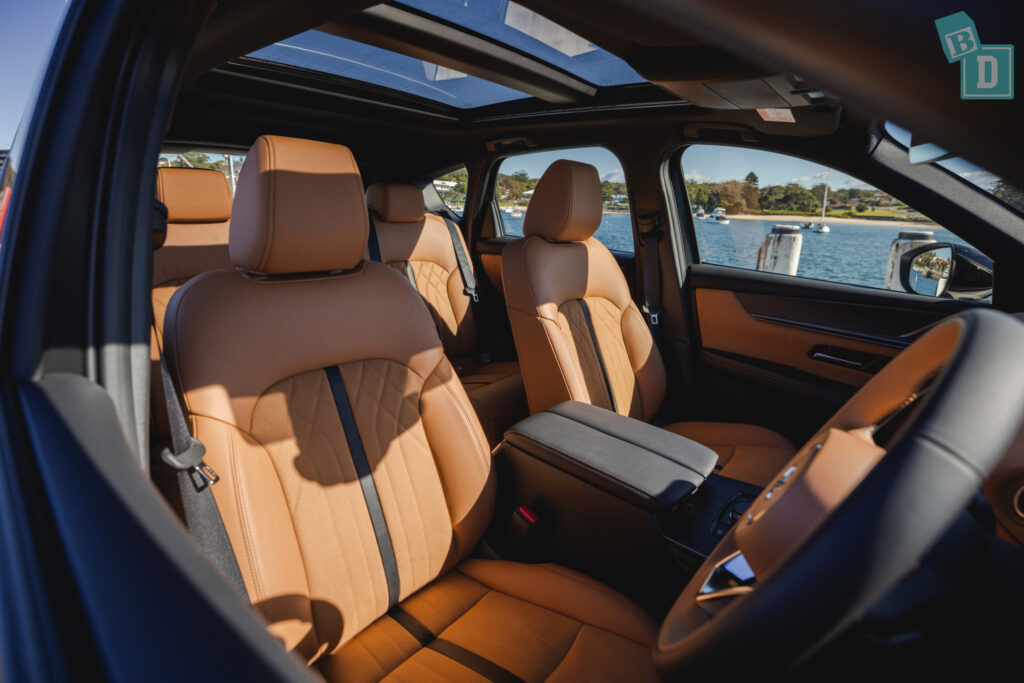 the interior of a suv with tan leather seats.
