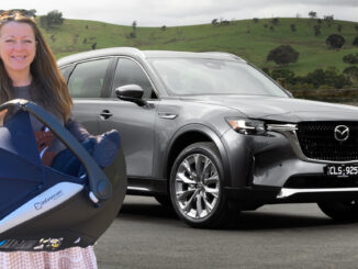 A woman standing in front of a 2023 Mazda CX-90 with a baby car seat.