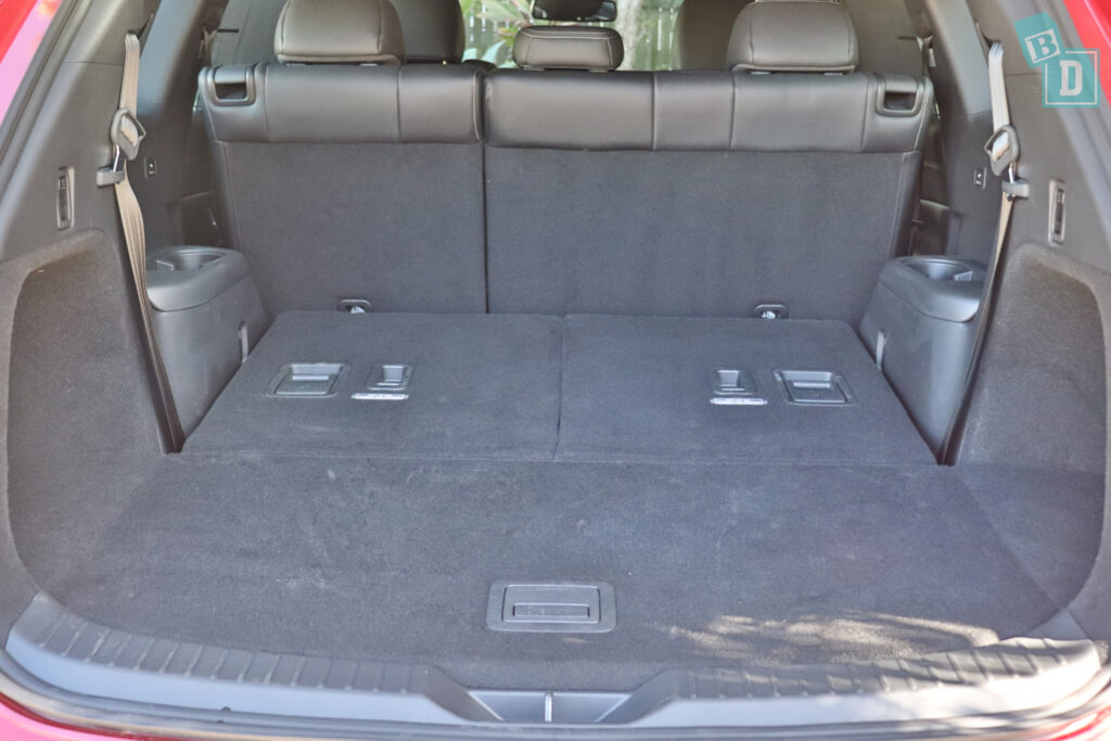 The rear cargo area of a red suv.