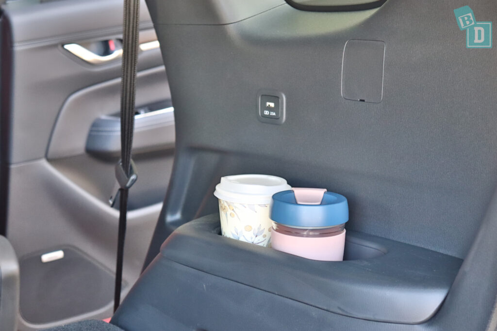 A cup in the back seat of a car.