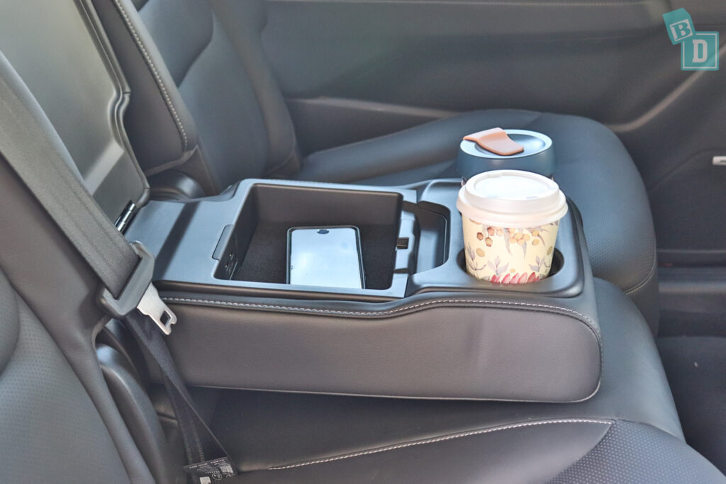 A cup holder in the back seat of a car.