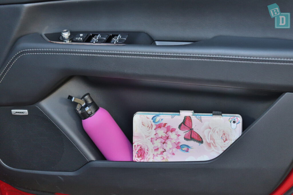 A car with a pink bottle in the back seat.