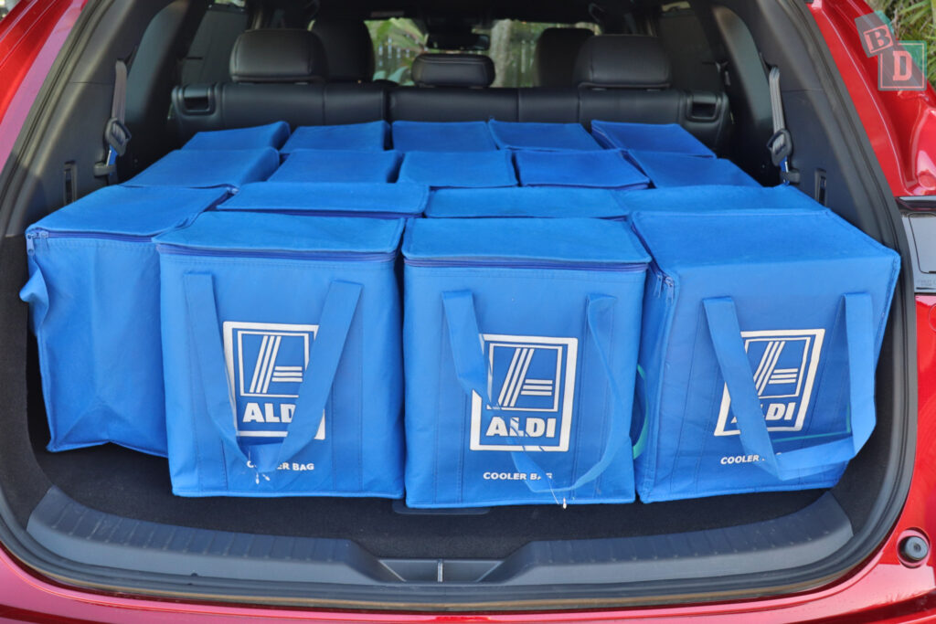 The trunk of a 2023 Mazda CX-8 is filled with blue bags.