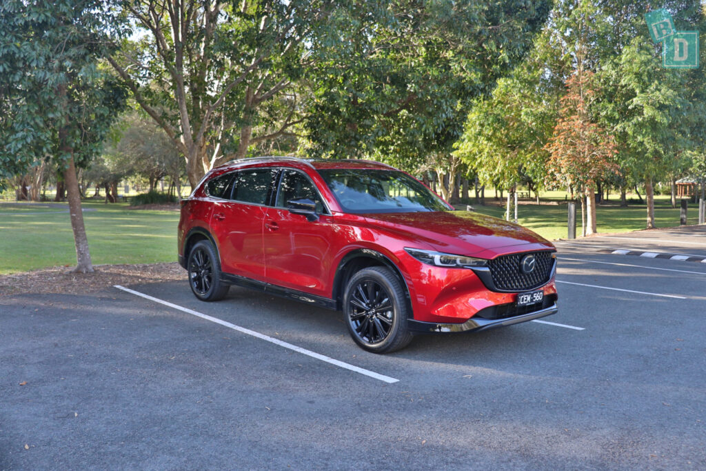 The red 2023 Mazda CX-8 parked in a parking lot.