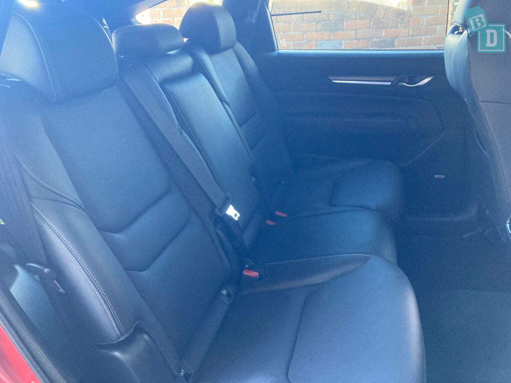 The back seats of a 2023 Mazda CX-8 with black leather seats.