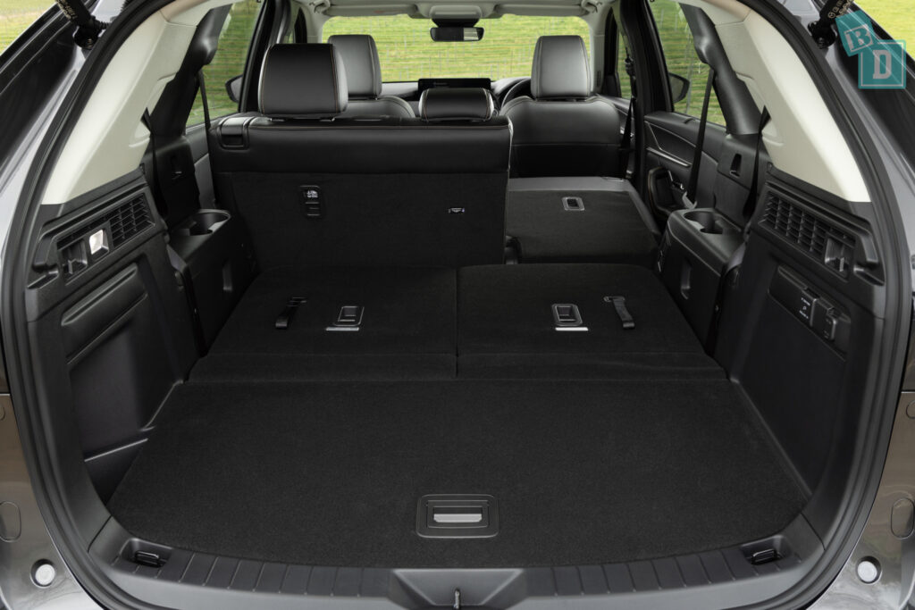 The trunk of a black suv with two seats.
