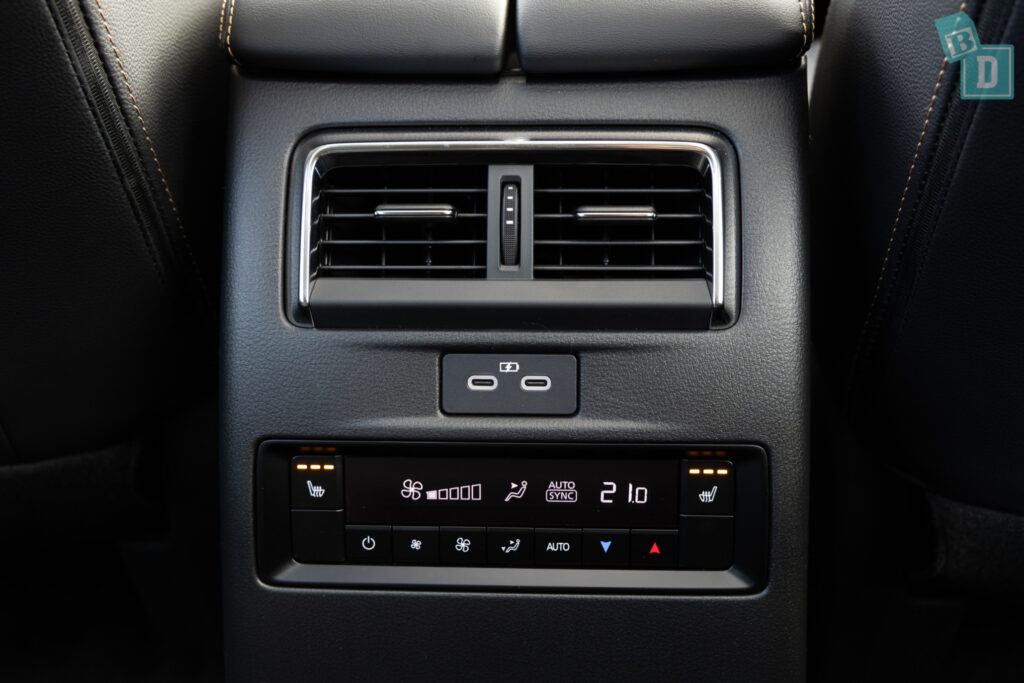 The interior of a 2023 Mazda CX-90 with second-row USB-C and air conditioning controls and vents