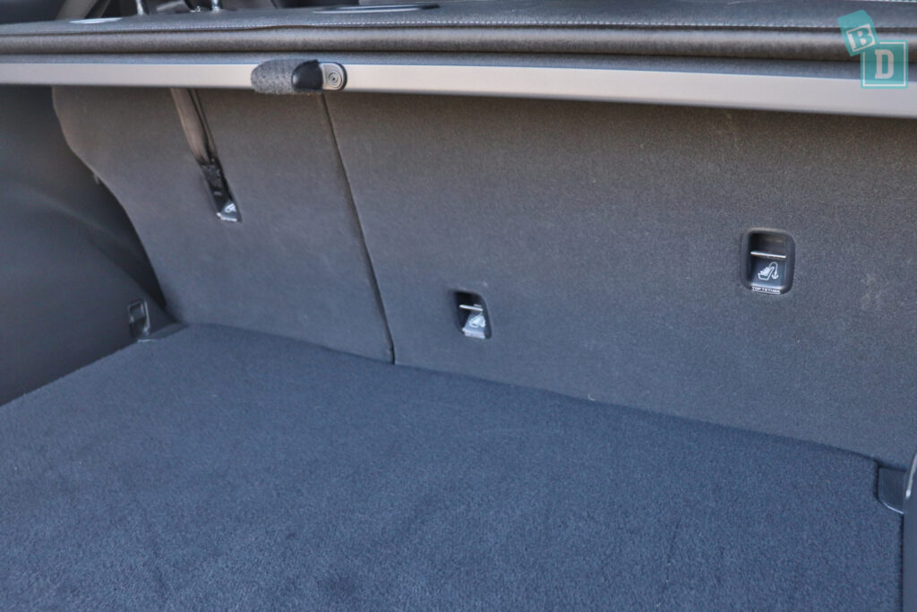 The trunk of a car with two seats and a seatbelt.