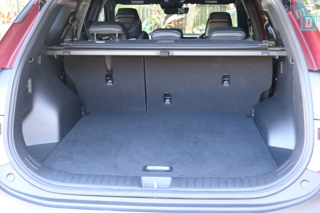 The trunk of a grey suv with two seats in it.