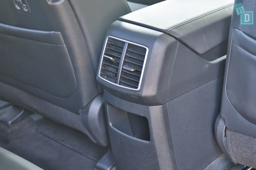 Air conditioning vents in the back seat of a car.