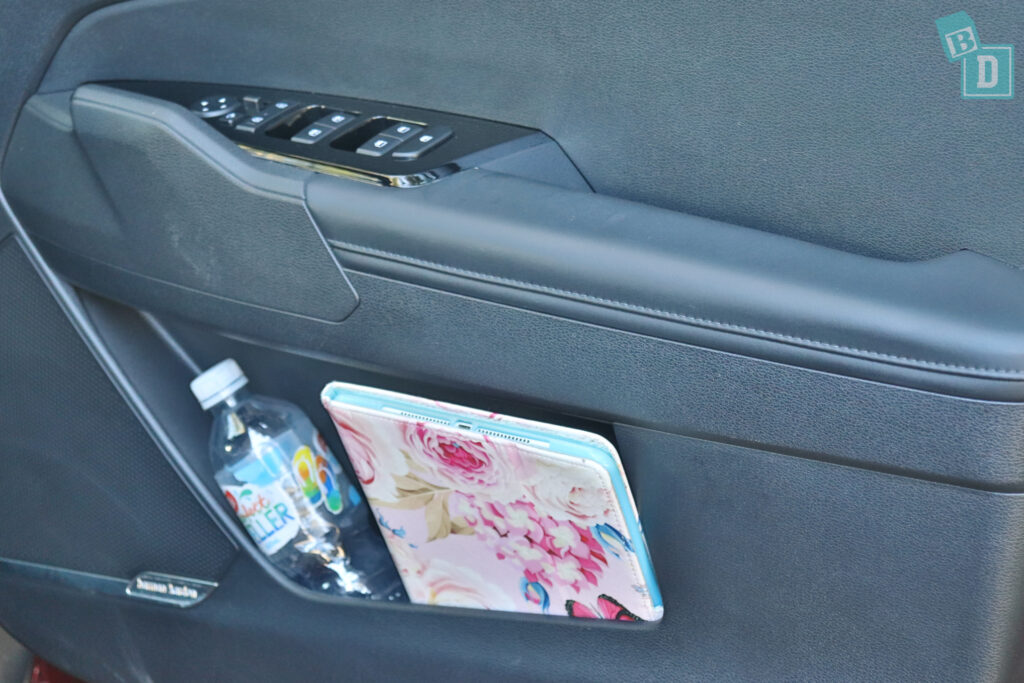 A car with a cup holder and a bottle of water.