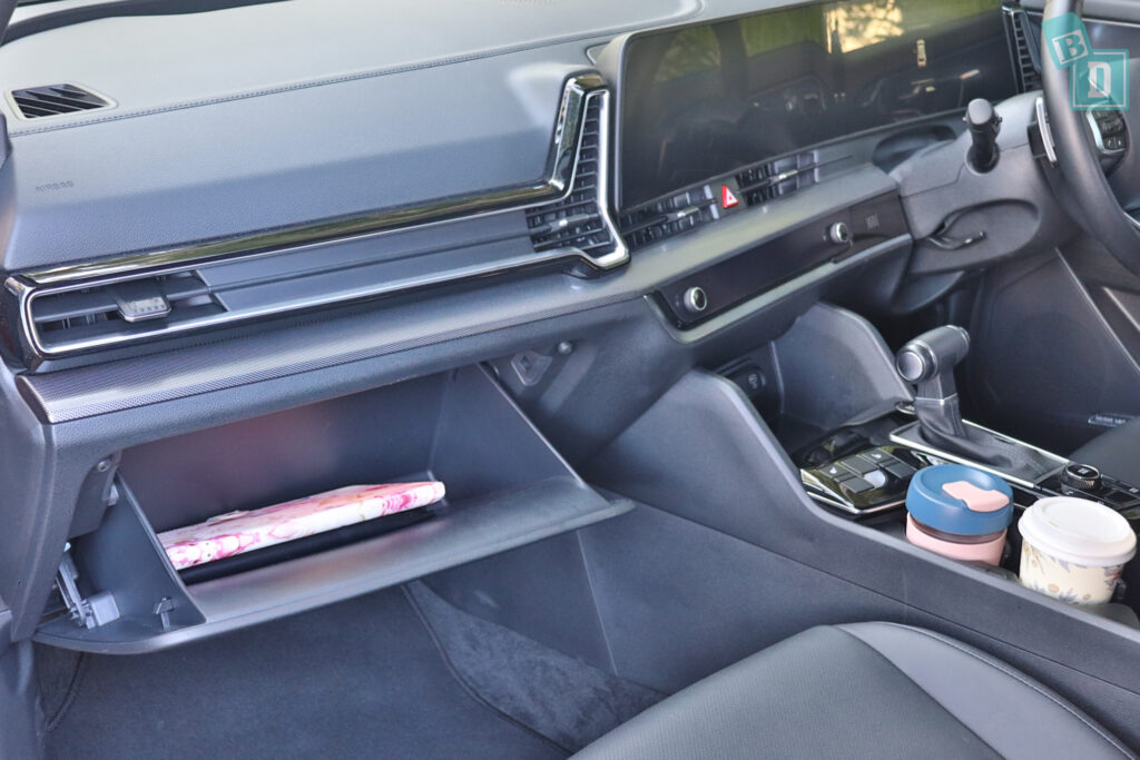 The interior of a car with a cup holder.