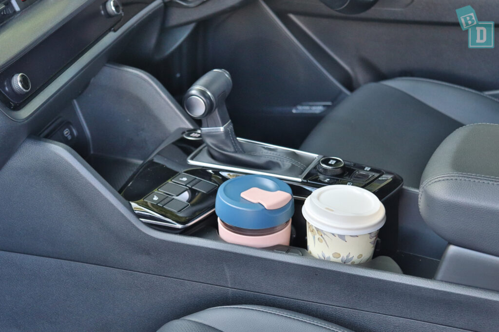 A cup holder in the center console of a car.