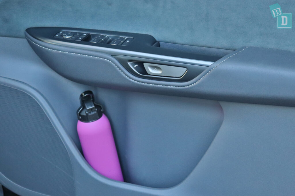 A car with a pink bottle in the back seat.