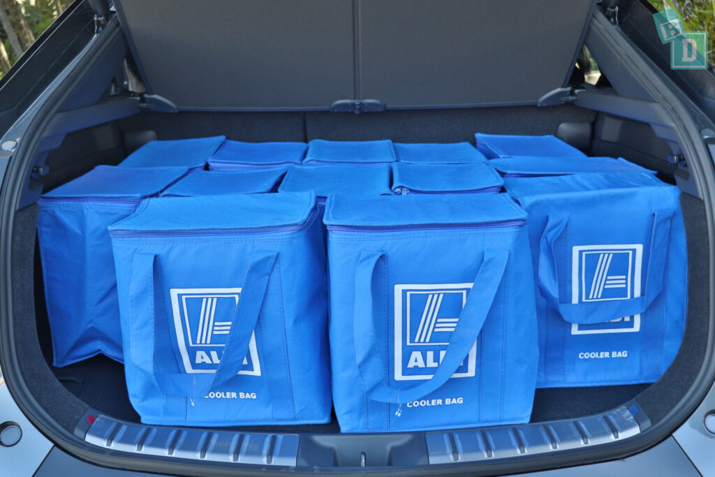 The trunk of a 2023 Lexus RZ 450e is filled with blue bags.