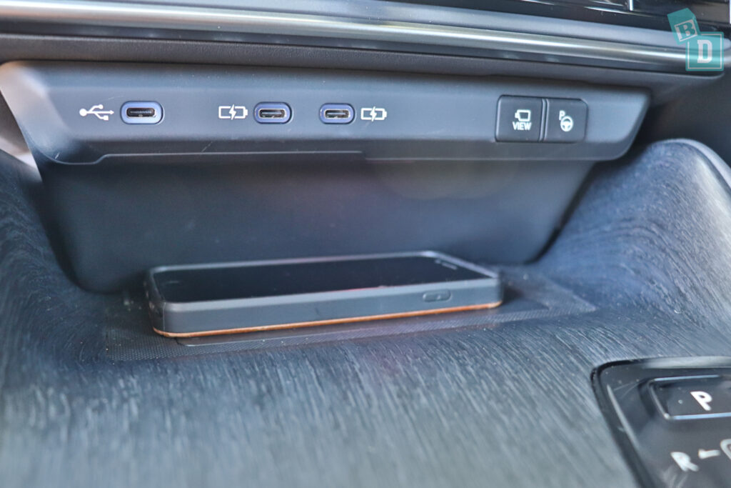 A car with a cell phone in the center console.