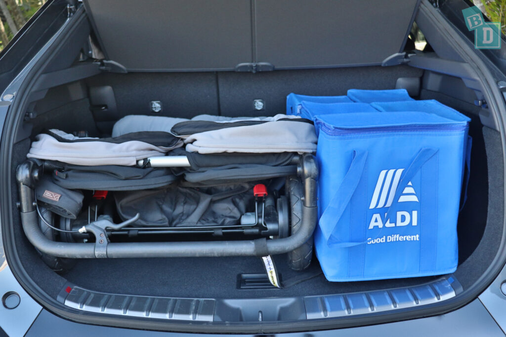 The trunk of a 2023 Lexus RZ 450e with double stroller and shopping