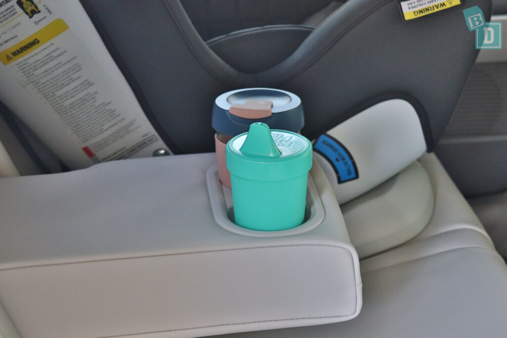 A child seat with a cup in it.