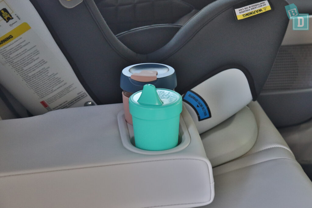 A cup holder in a car seat.