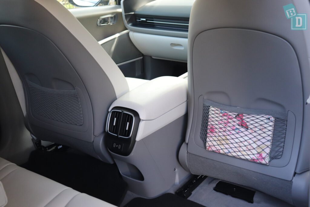 The back seats of a 2023 Hyundai Ioniq 6 with a seat cover.