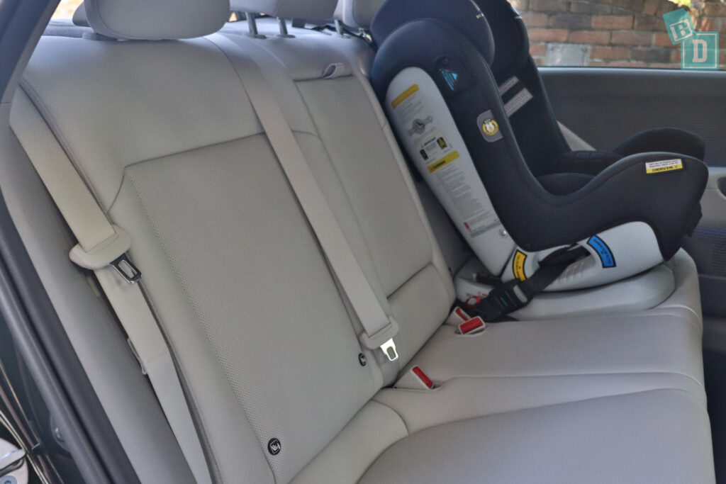 The back seat of a 2023 Hyundai Ioniq 6 with a baby car seat.