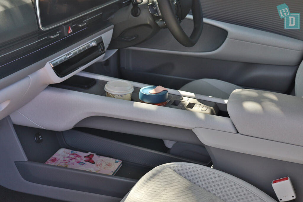 The interior of a car with a cup holder.