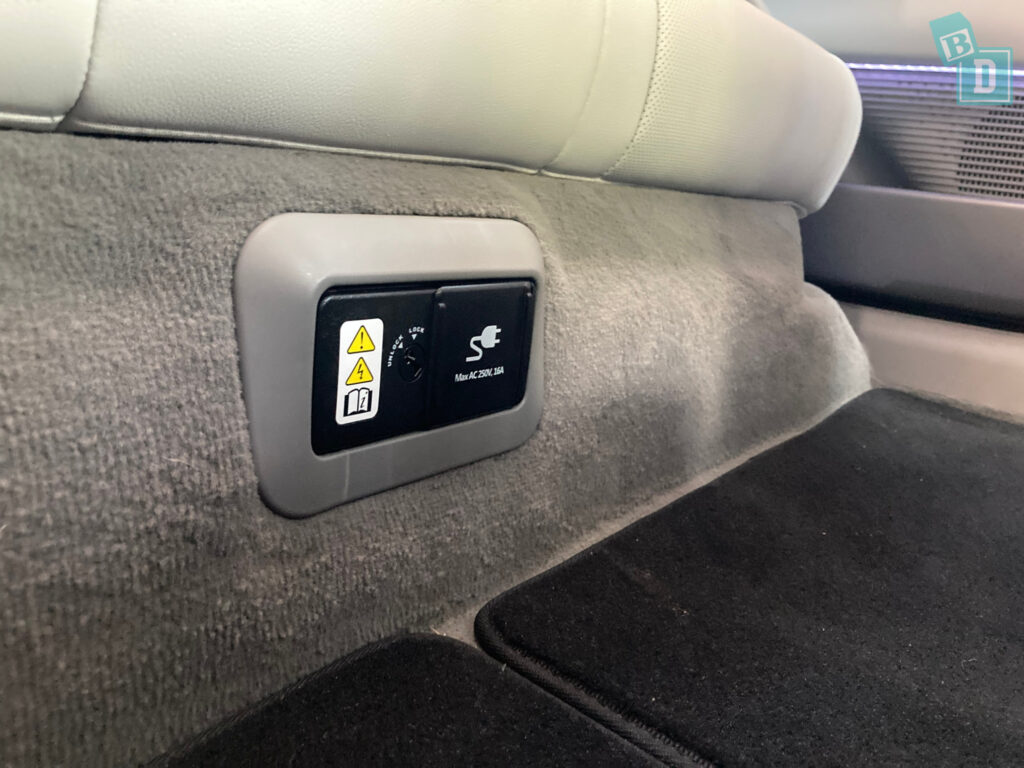 The back seat of a car has a button on it.