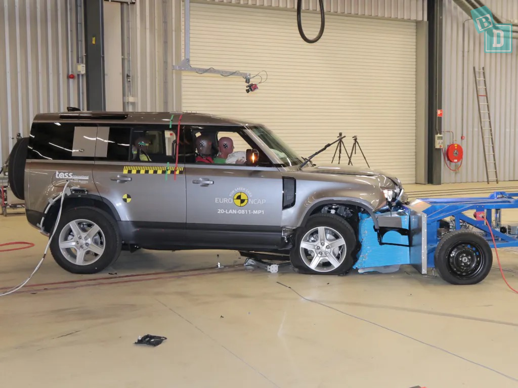 A land rover is being tested in a garage.